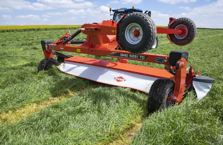 KUHN GMD 5251 TC large-width trailed disc mower on the road
